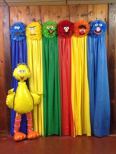 the sesame street characters are lined up in front of colorful curtains