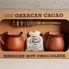 the mexican hot chocolate gift set includes two clay pitchers and an old - fashioned baseball bat