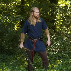 "A great way to add layers to an outfit or warmth on a crisp day. Our Short Sleeve Medieval Linen coats are a great addition to any medieval outfit, LARP kit, ren-faire costume and more! Our design is based on historical viking coats but we chose to make ours out of linen for a more lightweight feel and look. Designed with comfort and range of motion in mind, this garment is made to fit loose. Comes in sizes: XS (chest up to 36\") S (chest up to 40\") M (chest up to 44\") L (chest up to 48\") XL Easy Mens Ren Faire Costume, Viking Fashion Men, Ren Faire Costume Men, Viking Costume Men, Medieval Mens Clothing, Viking Coat, Medieval Man, Medieval Clothing Men, Medieval Outfit