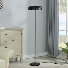 a black floor lamp in a living room