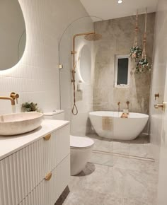 a bathroom with a tub, toilet and sink in it's center wall is shown