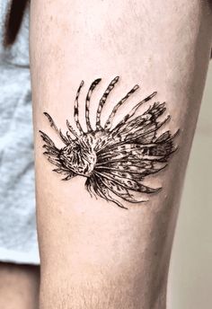 a black and white photo of a man's leg with tattoos on it