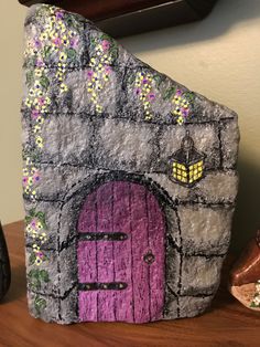 a rock with a purple door on it