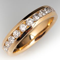 a yellow gold wedding ring with five rows of diamonds