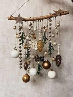 a mobile with ornaments hanging from it's sides and pine cones attached to the strings