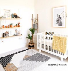 a baby's room with a white crib and shelves filled with books, plants and pictures