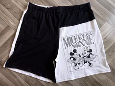 Discover the perfect blend of comfort, style, and sustainability with our black and white Mickey and Minnie unisex shorts upcycled from repurposed t-shirts at Woo's Fashion. Designed as ideal loungewear, these loose and comfy fit, boxer-style shorts feature an elastic waistband for maximum comfort. Committed to sustainable fashion, these eco-friendly shorts let you save the planet while enjoying unique, handmade gifts. Embrace the charm of Mickey and Minnie in every relaxed moment. Measurements Summer Patchwork Shorts For Streetwear, Summer Streetwear Shorts With Patchwork, Summer Streetwear Patchwork Shorts, Black Patchwork Shorts, White Patchwork Short Bottoms, Black Patchwork Short Bottoms, White Patchwork Shorts For Summer, Mickey Und Minnie, Mickey Shorts