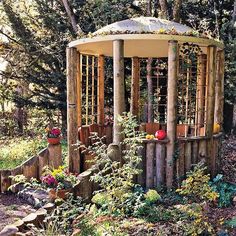 a wooden gazebo surrounded by trees and plants