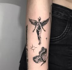 a woman with a tattoo on her arm has a cross and two butterflies in front of her