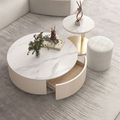 a white marble coffee table sitting on top of a wooden floor next to a plant