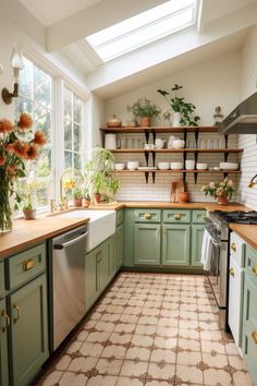 a kitchen filled with lots of green cabinets and counter top space next to a window