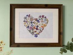 a heart made out of flowers on a wall