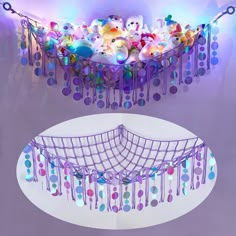 an artistic display with teddy bears and lights in the ceiling, suspended from strings over a circular white table