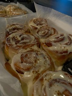 some cinnamon rolls sitting on top of wax paper