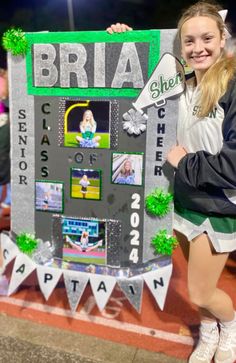 a girl holding up a sign that says bria she's class of 2012