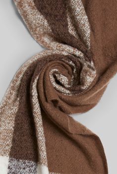 This winter scarf embraces earthy tones, with shades of warm brown and crisp white interwoven seamlessly. Its fringed edges lend a rustic touch, evoking a cosy, handcrafted feel. The fabric is plush and insulating, a James Lakeland favourite. 100% Polyester.  Professional Clean Only Check Scarf, Checked Scarf, British Heritage, Women's Hats, Warm Brown, Fine Fabric, Independent Designers Fashion, Earthy Tones, Personal Stylist