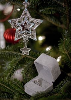 an ornament hanging from a christmas tree in the shape of a snowflake