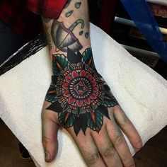 a person with a tattoo on their hand