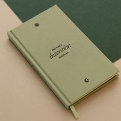 a green book sitting on top of a table