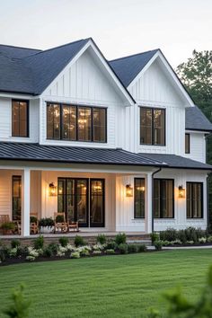 a large white house with lots of windows on the front and side of it's roof