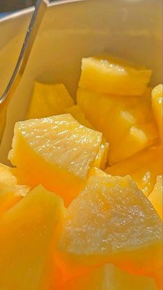 a bowl filled with sliced up yellow fruit