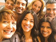 a group of people are posing for a photo with one woman smiling at the camera