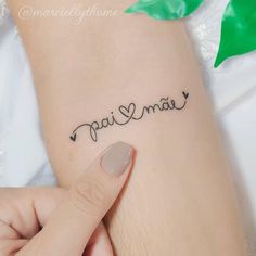 a woman's hand with a small tattoo on her wrist that reads, paris