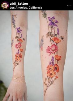 two women with tattoos on their arms and one has flowers painted on her arm, while the other is wearing a gold bracelet