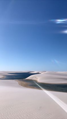 the sun shines brightly over an expanse of white sand