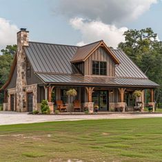 a large house with a metal roof and stone pillars