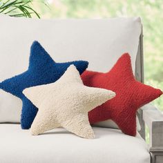 two red, white and blue stars are sitting on a couch next to each other