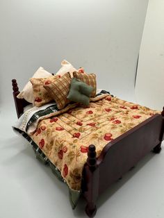 a bed with two pillows on top of it next to a white wall and floor