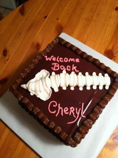 a welcome back cake with chocolate icing and white frosting in the shape of a skeleton