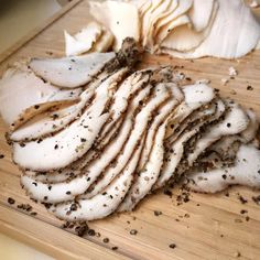 sliced up chicken on a cutting board with spices