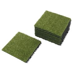 four pieces of artificial grass are stacked on top of each other in front of a white background