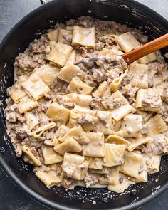 a skillet filled with pasta and meat