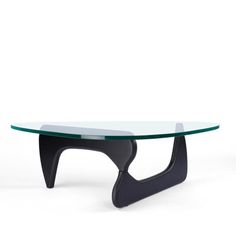 an oval glass table with black legs and a curved design on the top, against a white background