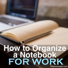 an open notebook sitting on top of a desk next to a laptop computer