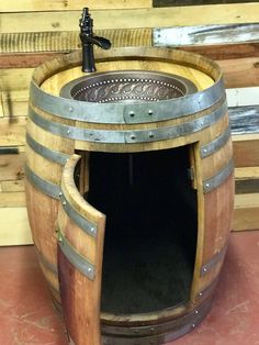 a wooden barrel with a tapper in the middle and a sink on top that is made out of wine casks