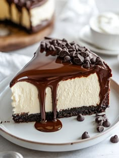 a piece of cheesecake on a plate with chocolate sauce and oreo pieces around it