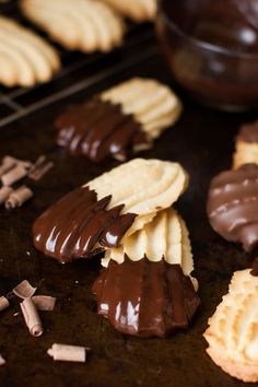 chocolate dipped cookies are arranged on a baking sheet