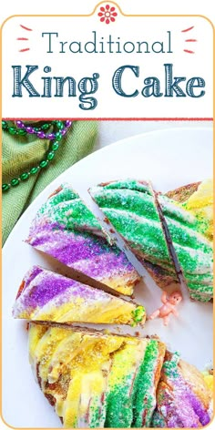 a white plate topped with colorful cake next to a green and yellow baguette