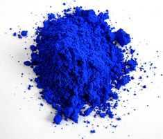 a pile of blue powder sitting on top of a white table