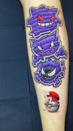 an arm with some tattoos on it and a cartoon character in the middle of it