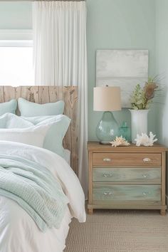 a bed sitting next to a window with curtains on top of it and a dresser in front of it