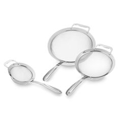 three stainless steel pans with handles and lids on a white background, one is empty