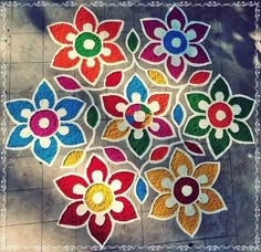 a bunch of colorful flowers sitting on top of a tile floor