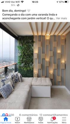 a living room filled with lots of furniture next to a tall window covered in greenery