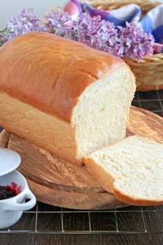 a loaf of bread sitting on top of a wooden cutting board