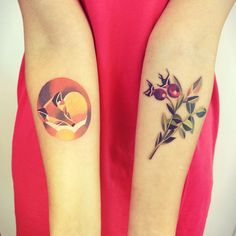 two women with matching tattoos on their arms